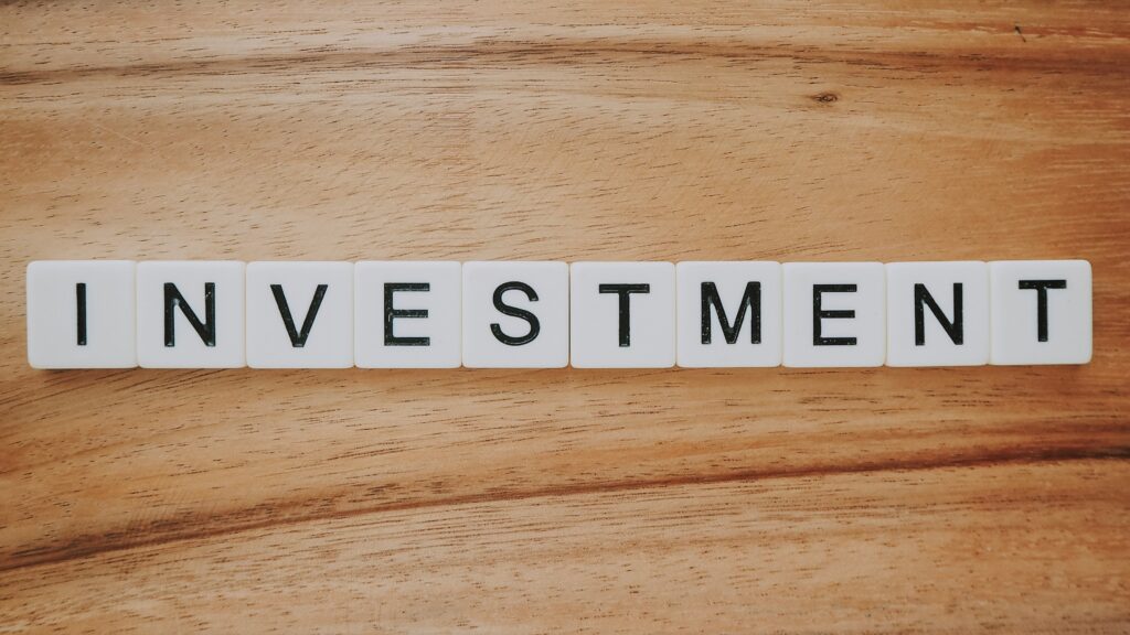 The words "INVESTMENT" arranged with Scrabble letters