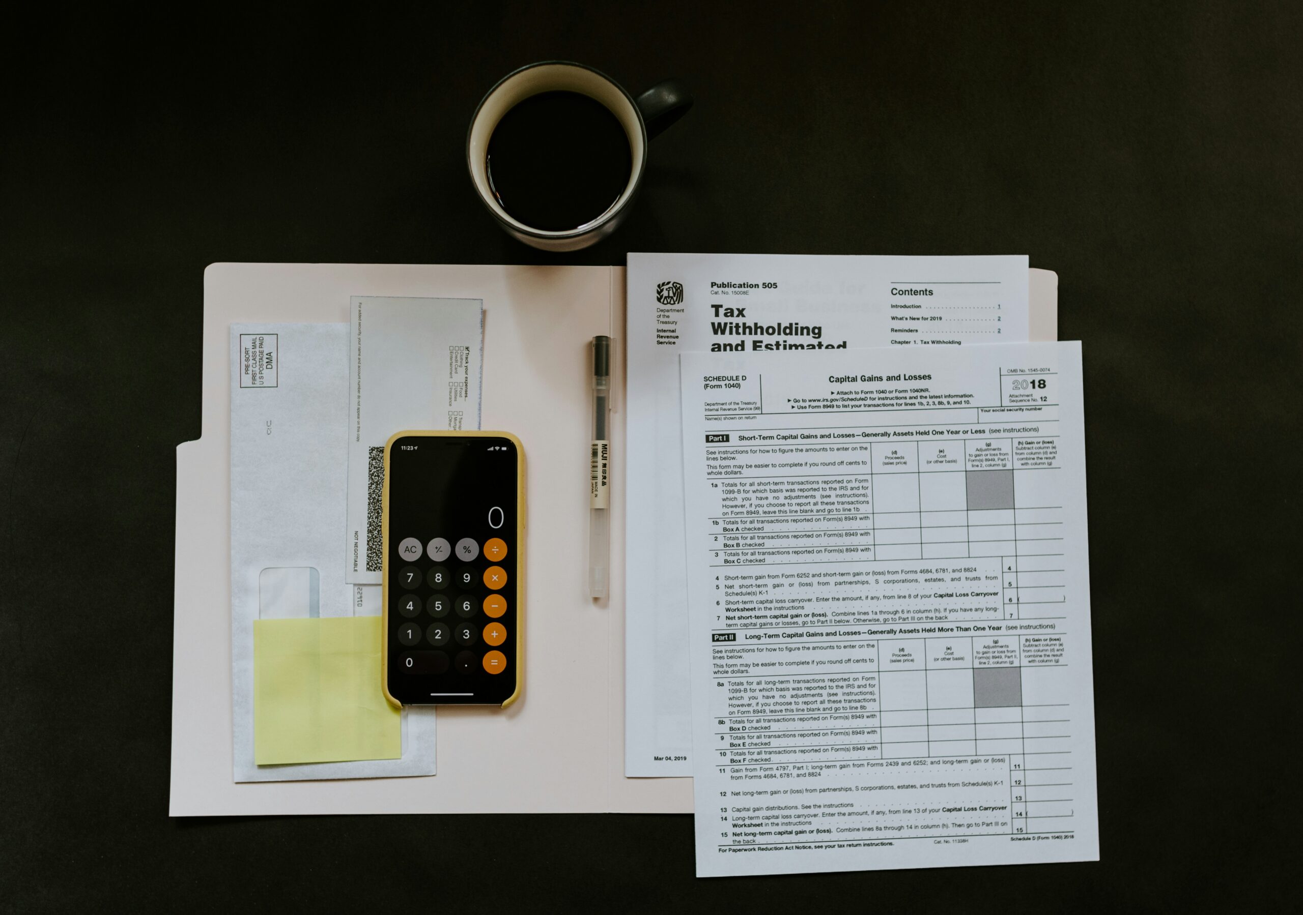 A calculator and some financial statements on a able
