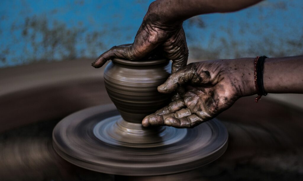 Someone making a clay vessel